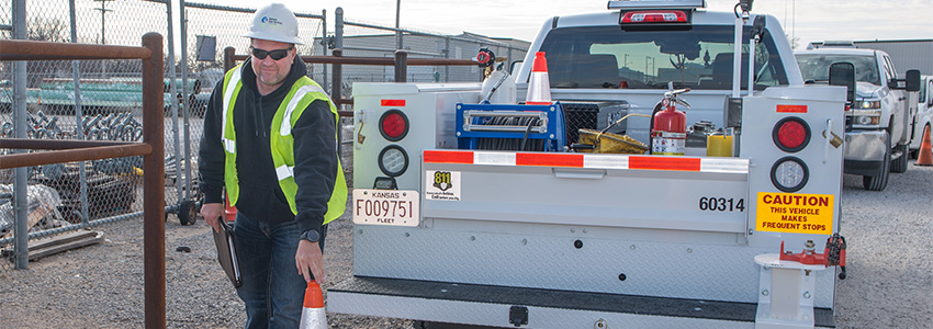 Kansas Gas Service truck employee with safety cone